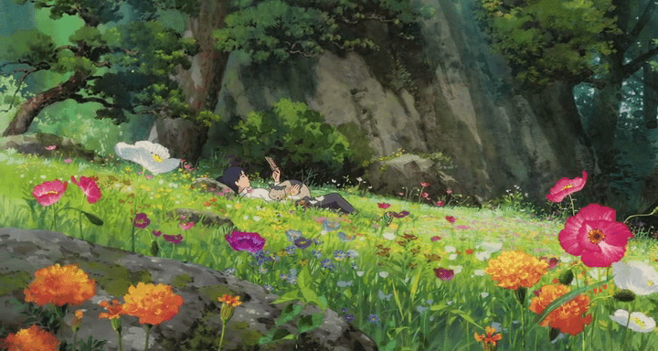 il giardino di arrietty con fiori e ragazzo steso a leggere