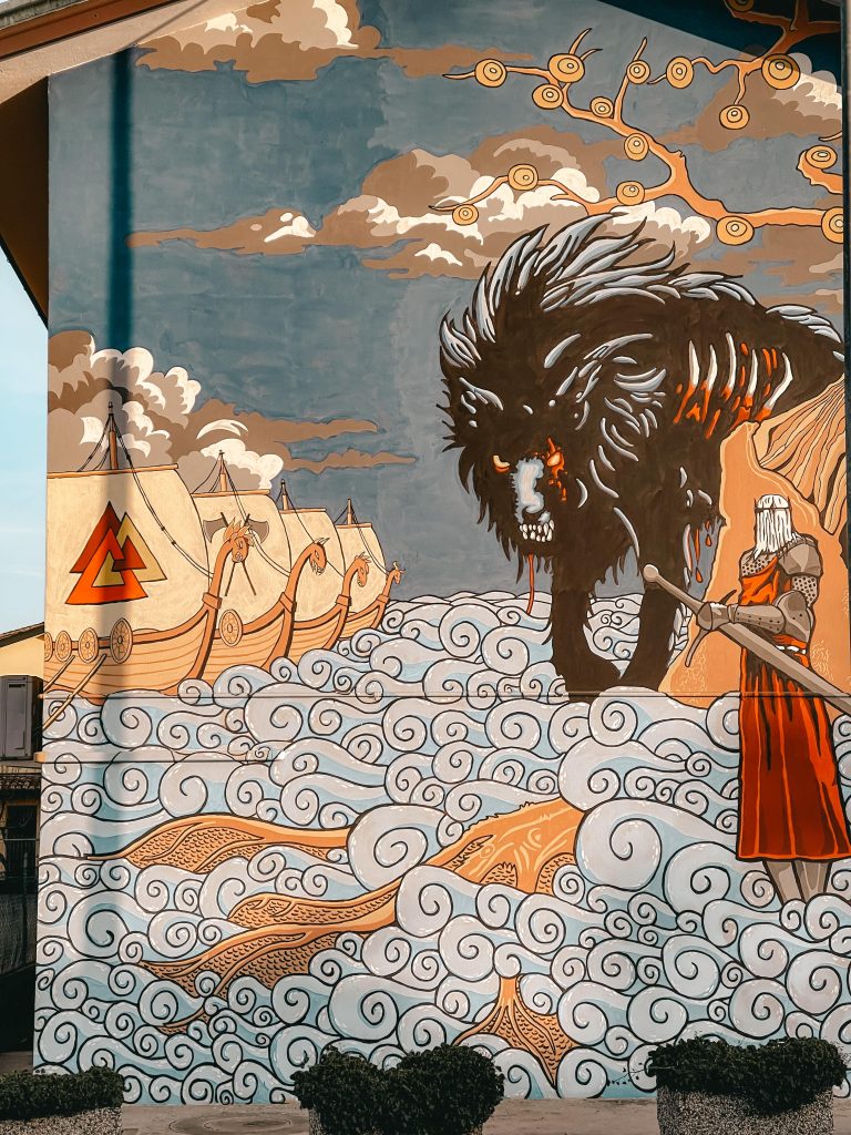 murales con il lupo e i giganti di ghiaccio che assaltano asgard